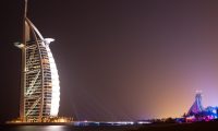 "Dubai, United Arab Emirates - May 11, 2011: Burj al Arab hotel, one of the few 7 stars hotel in the world and one of the most recognized luxury symbol at night while a VIP party is going on the beach"