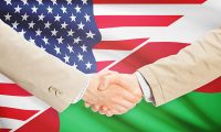 Businessmen shaking hands - United States and Oman