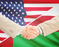 Businessmen shaking hands - United States and Oman